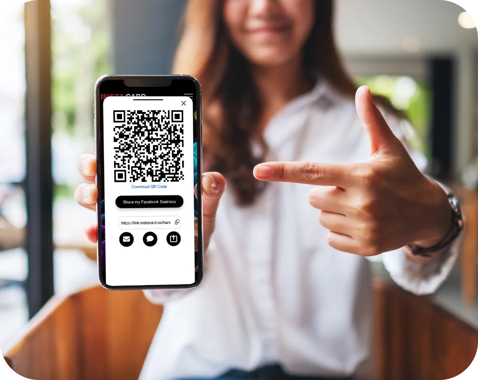 photo of a woman pointing at a phone featuring the share qr code feature of the instacard